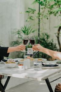 a group of people sitting at a table with wine glasses at Airport Transit Villa in Minuwangoda