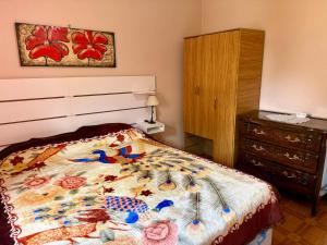 a bedroom with a bed and a dresser at Quintacolastinenorte in Santa Fe +7 photos