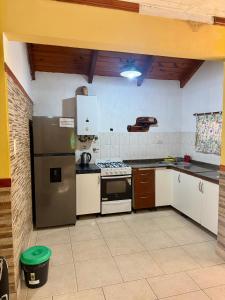 a kitchen with a refrigerator and a stove top oven at Quintacolastinenorte in Santa Fe