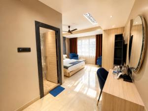 a hotel room with a bed and a mirror at The Bay Suites - NIS in kolkata