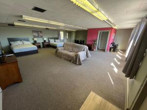 a hotel room with a bed and a couch and a chair at House # 9 in Las Vegas