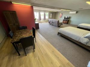 a bedroom with a bed and a desk and a table at House # 9 in Las Vegas