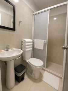 a bathroom with a toilet and a sink and a shower at HOTEL ELITE in Cali