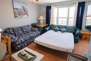 a living room with a couch and a couch and a table at EZ Beach Access Great Family Condo SpaceX view in South Padre Island +85 photos