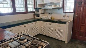 a kitchen with a stove and a counter top at Nyali Garden Escape Villa in Mombasa