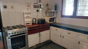 a kitchen with a stove and a microwave at Nyali Garden Escape Villa in Mombasa