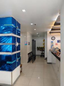 a hallway with blue plastic shelves in a room at Nice Hotel Aurora Cubao in Manila