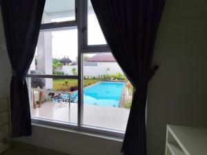 a view of a swimming pool from a window at Menepi Bali in Uluwatu