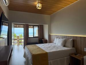 a bedroom with a bed with a view of the ocean at G2 Beach Hotel in Aquiraz +89 photos