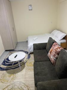 a living room with a couch and a bed at Reiroy homes in Kikuyu