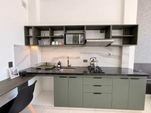 a kitchen with a counter with a sink and a microwave at Forty 125 in Tarija