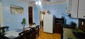 a kitchen with a table and a white refrigerator at Eagle's Hub Niagara ny in Niagara Falls +7 photos