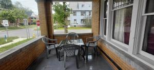 a patio with a table and chairs on a porch at Eagle's Hub Niagara ny in Niagara Falls