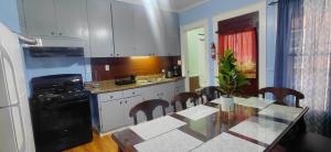 a kitchen with a dining table and a kitchen with a stove at Eagle's Hub Niagara ny in Niagara Falls