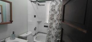 a bathroom with a sink and a shower curtain at Eagle's Hub Niagara ny in Niagara Falls