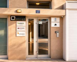 an entrance to a building with a glass door at Urban Temple Apartment near Cathedral Free Parking in Podgorica