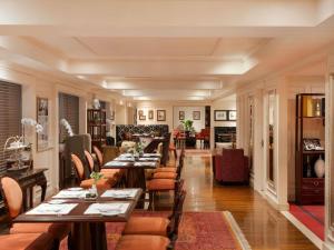 a dining room with long tables and chairs at Sofitel Legend Metropole Hanoi in Hanoi