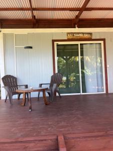 two chairs and a wooden table in front of a building at Kai Kabana Chill in HUH