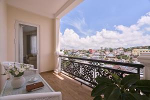 a balcony with a view of a city at Nature Hotel and Suite in Da Lat