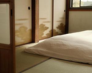 a close up of a bed in a room at Omoya Kitahata in Karatsu
