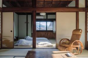 a bedroom with a bed and a glass wall at Omoya Kitahata in Karatsu