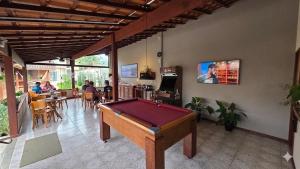 a pool table in the middle of a room at Pousada das Saíras in Paraty