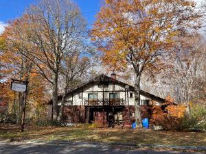 an old stone house in the middle of trees at Ikiru Lodge in Yamanouchi +6 photos