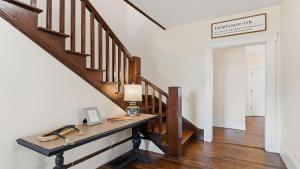 a staircase with a wooden table in a room at Brevard Bliss in Brevard