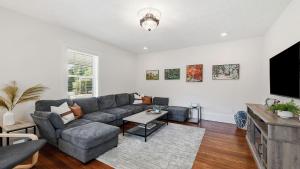 a living room with a couch and a tv at Brevard Bliss in Brevard