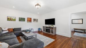 a living room with a couch and a television at Brevard Bliss in Brevard