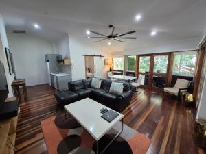 a living room with a couch and a table at South Pacific Resort & Spa Noosa in Noosaville