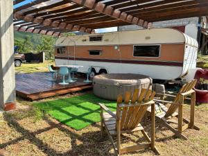 an rv parked on a wooden deck with a chair at Tiny house móvel com vista 360 in São Roque +11 photos