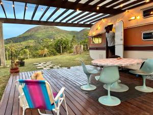 an rv with a table and chairs on a deck at Tiny house móvel com vista 360 in São Roque