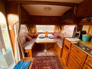 a living room with a table in the middle of a rv at Tiny house móvel com vista 360 in São Roque