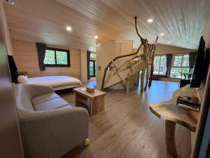 a room with a bed and a couch in a room at 木木杉民宿 in Puli