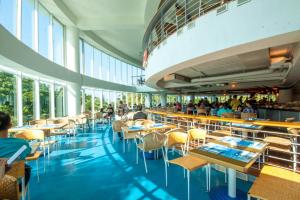 a restaurant with tables and chairs in a building at Yoho Beach Resort Kenting in Hengchun South Gate