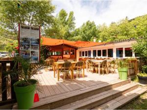 a patio with tables and chairs and a restaurant at Chalet - Animaux admis - 4 pers. - API-1-52-2942 in Annot