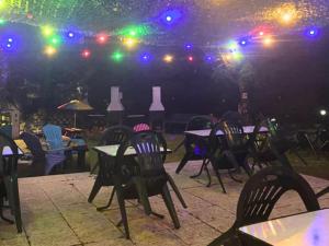 a group of tables and chairs at a restaurant at night at Chalet - Animaux admis - 4 pers. - API-1-52-2942 in Annot