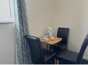 a small table with two chairs and a table with a lamp at The Goodlife Guesthouse in Harwich