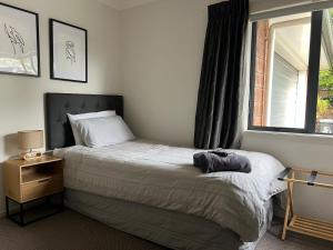 a bedroom with a bed and a window at Convenient in Cambridge in Cambridge