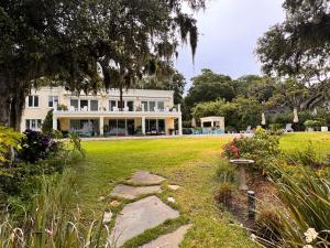 a large white house with a garden in front of it at Waterway in Charleston