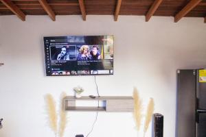 a flat screen tv hanging on a wall at Aparta estudio in Itagüí