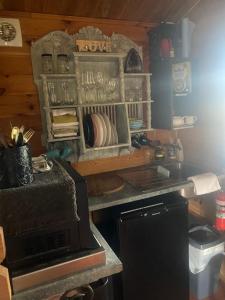 a kitchen with a counter with plates and glasses at A place to be in Kurmond