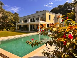a house with a swimming pool in front of a house at Waterway in Charleston
