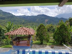 a view of a resort with a view of mountains at Finca de las banderas in Jardin +6 photos