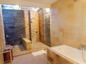 a bathroom with a shower and a bath tub at Amed Santorini Villa in Amed +71 photos