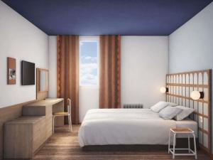 a bedroom with a large bed and a window at Greet Lourdes Centre Pyrenees in Lourdes