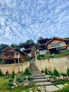 a group of houses on a hill with stairs at Wojia我家 in Ban Rak Thai