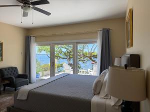 a bedroom with a bed and a view of the ocean at Waterway in Charleston