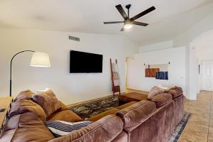 a living room with a couch and a flat screen tv at Suitewater in Peoria